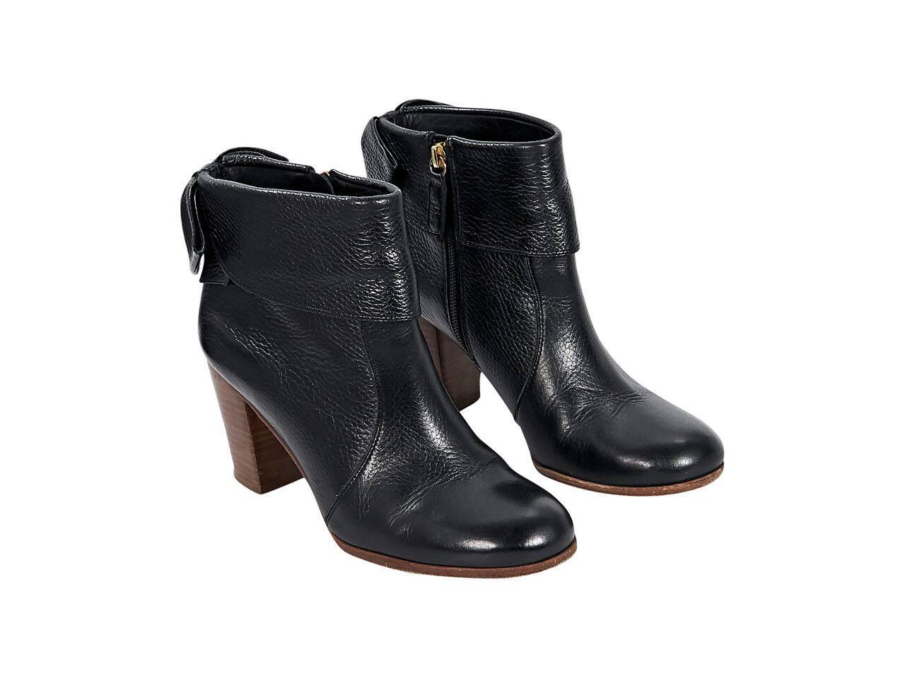 Product details:  Black pebbled leather ankle boots by Kate Spade New York.  Bows accent back of shaft.  Round toe.  Chunky stacked heel.  Inner zip closure.  
Condition: Pre-owned. Very good.
Est. Retail $ 448.00