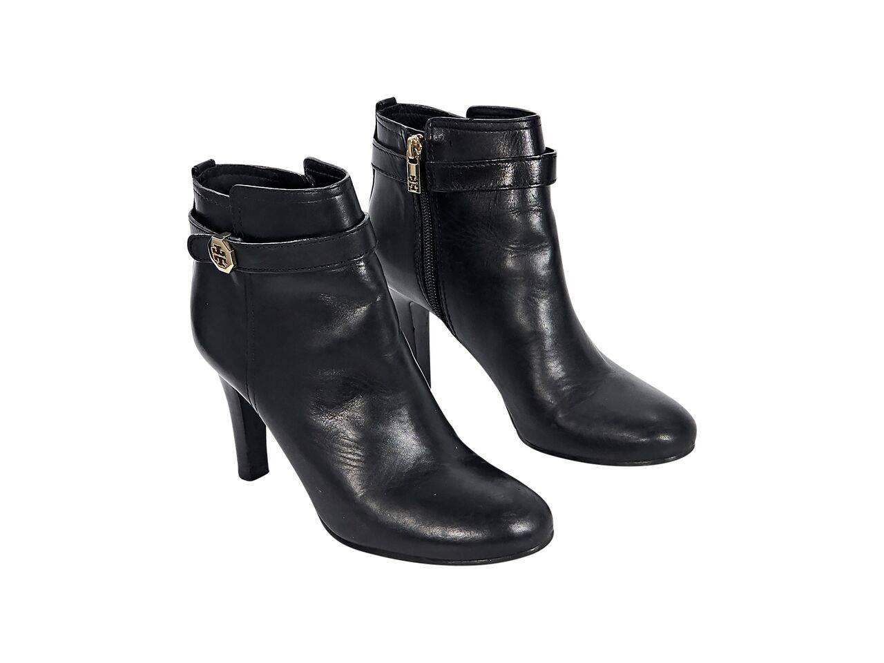 Product details:  Black leather ankle boots by Tory Burch.  Ankle strap accent.  Round toe.  Inner zip closure.  Goldtone hardware.  
Condition: Pre-owned. Very good.
Est. Retail $ 498.00