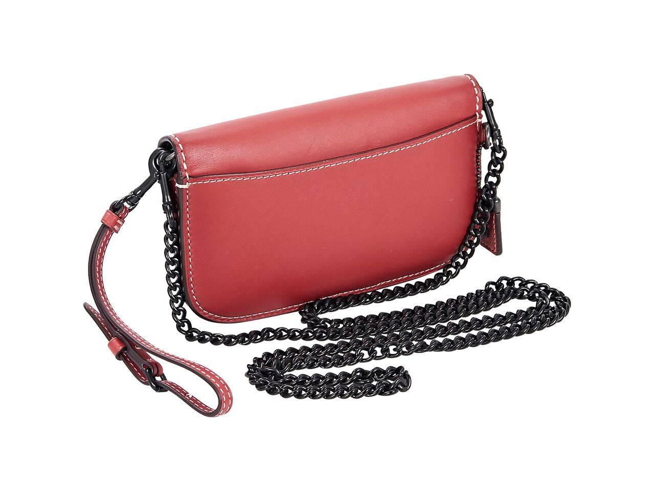 Product details:  Red leather crossbody bag by Coach.  Detachable wristlet strap.  Detachable chain crossbody strap.  Front flap.  Snap closure.  Leather interior with inner center zip pouch and credit card slots.  Black hardware.  7.25