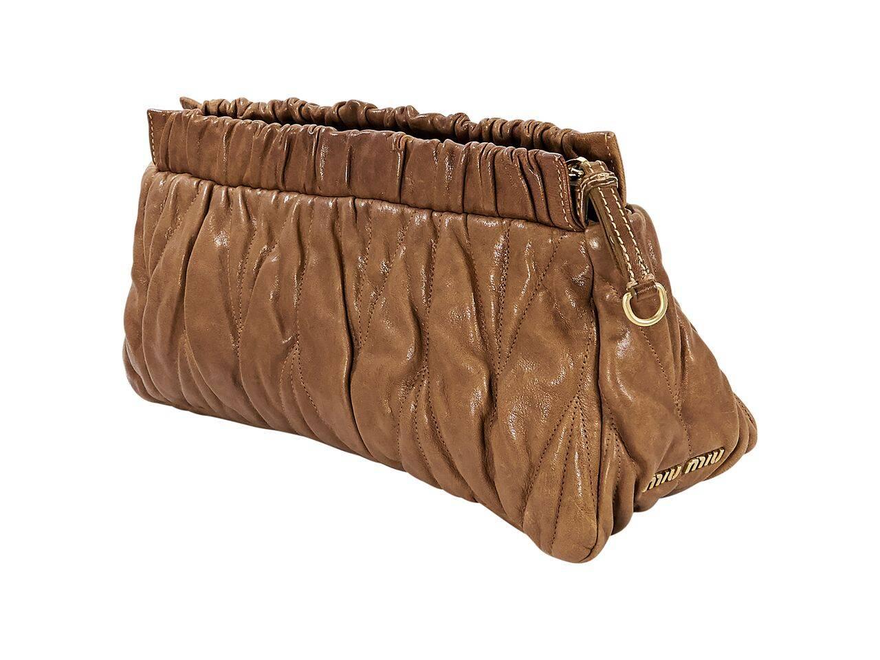 Product details:  Brown leather clutch by Miu Miu.  Top zip closure.  Lined interior with inner zip pocket.  Goldtone hardware.  12