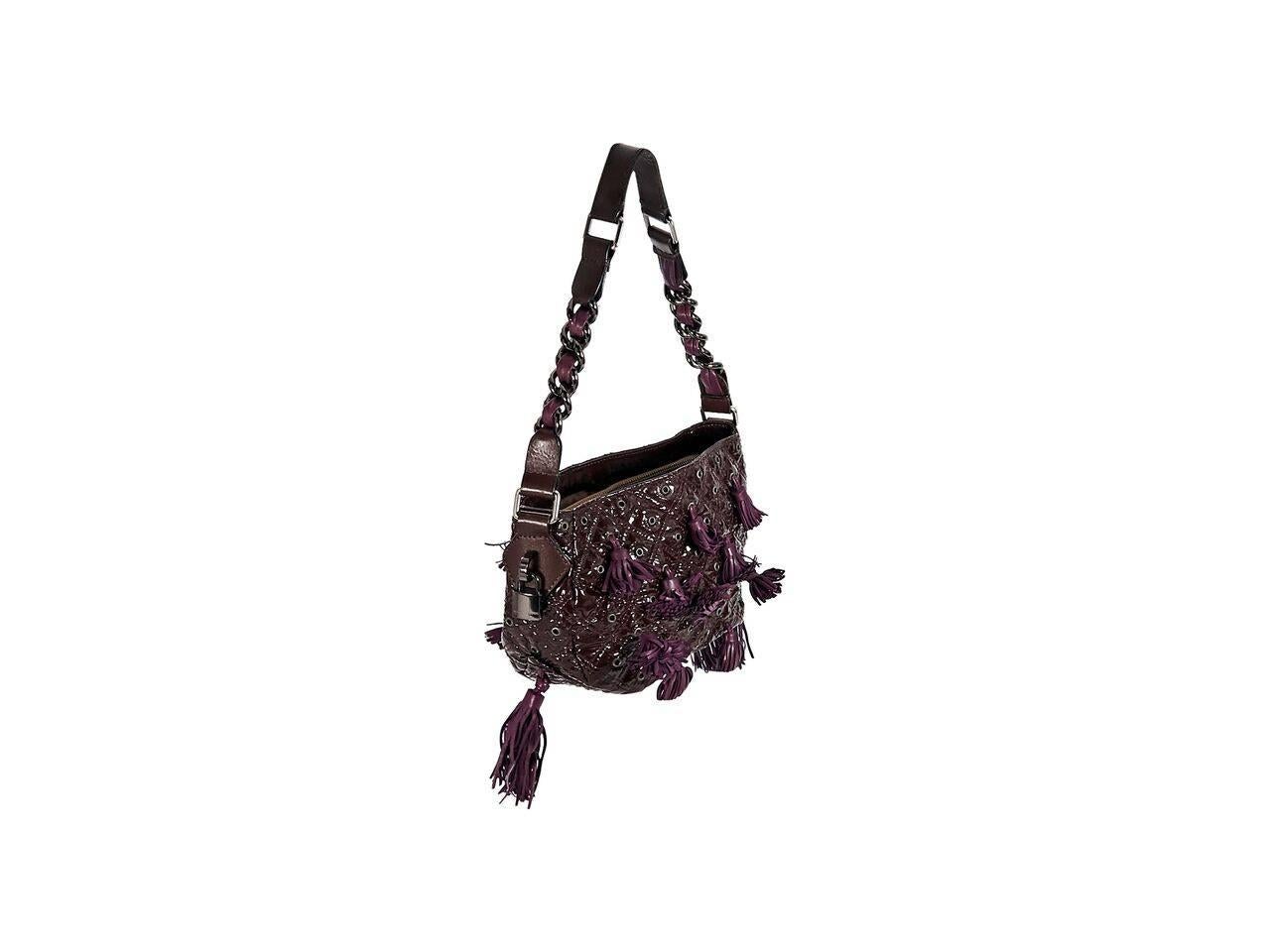 Product details:  Purple quilted patent leather Dancer shoulder bag by Marc Jacobs.  Accented with grommets and tassels.  Single shoulder strap.  Open top.  Lined interior with inner center zip compartment and zip pocket.  Gunmetal-tone hardware. 