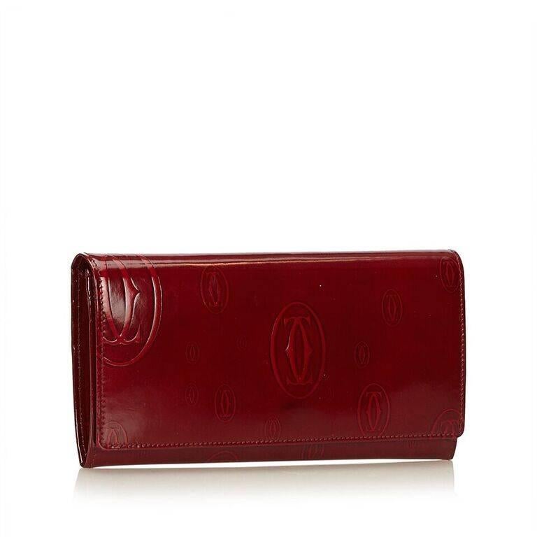 Product details:  Red patent leather Happy Birthday long wallet by Cartier.  Front flap with snap closure.  Multiple inner credit card slots, bill compartment and zip coin pouch.  Silvertone hardware.  7"L x 4"H x 1"D.  Authenticity