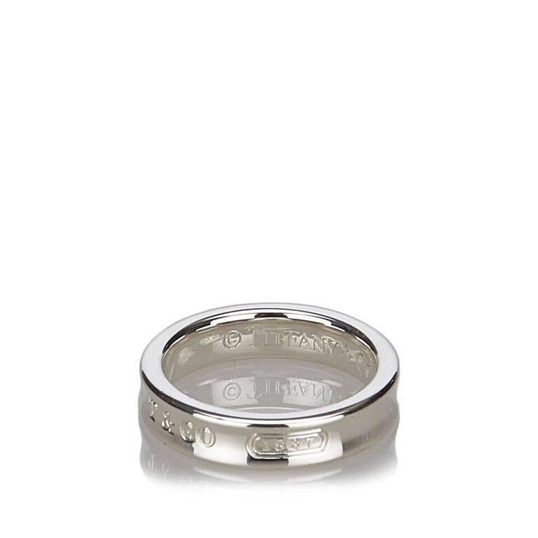 Product details:  Sterling silver 1837 ring by Tiffany & Co.  Engraved design.  Ring size 51.
Condition: Pre-owned. Excellent. 
Est. Retail $ 175.00