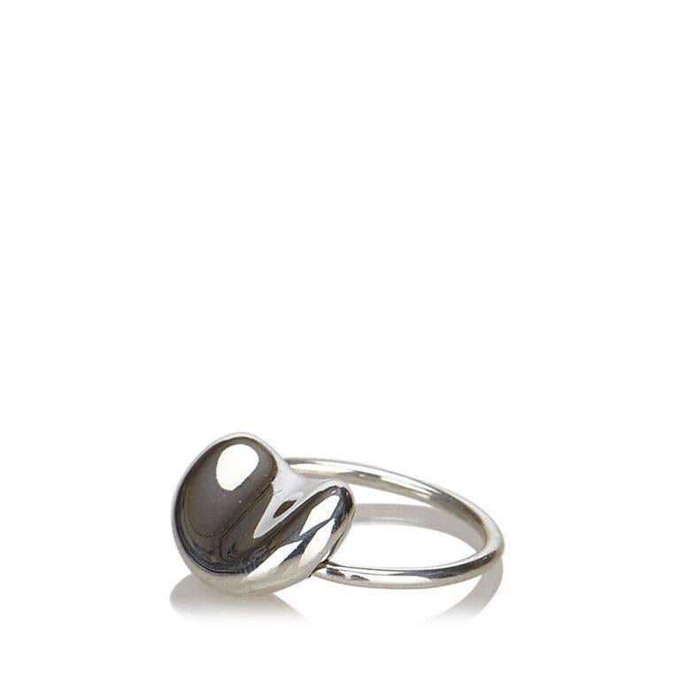 Product details:  Sterling silver bean ring by Tiffany & Co.  Ring size US 4.5/Euro 48.
Condition: Pre-owned. Very good. 
Est. Retail $ 200.00
