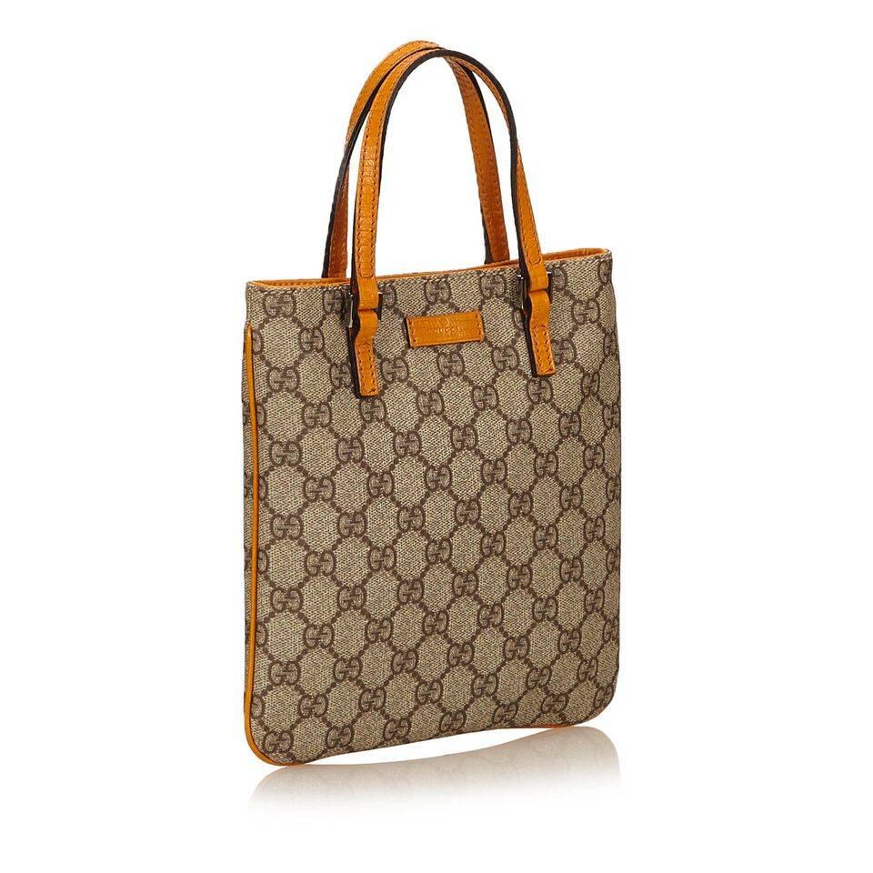 Product details:  Tan Guccissima PVC tote bag by Gucci.  Dual leather carry handles.  Magnetic snap closure.  Lined interior with inner zip pocket.  Silvertone hardware.  8