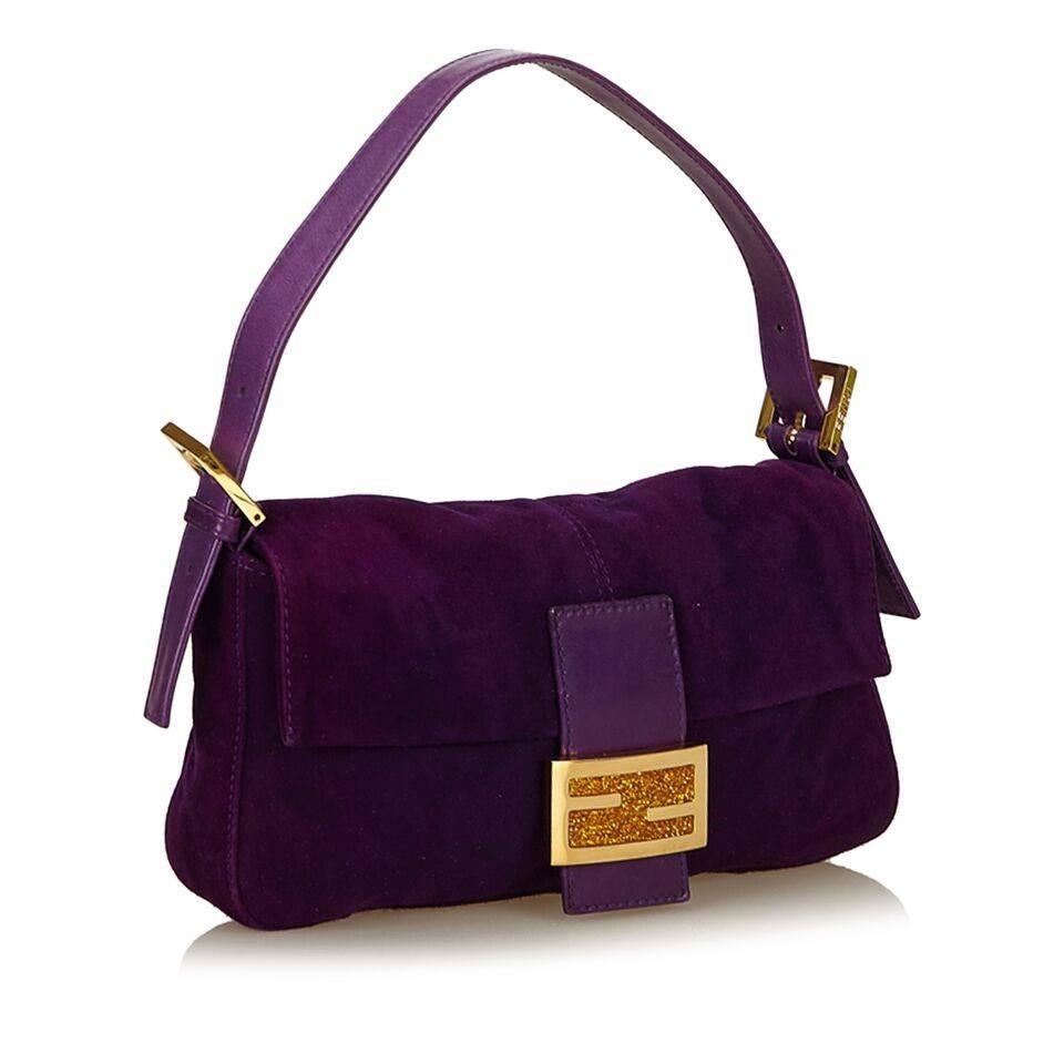 Product details:  Purple nubuck leather baguette shoulder bag by Fendi.  Adjustable single shoulder strap.  Front flap.  Lined interior with inner zip pocket.  Goldtone hardware.  10