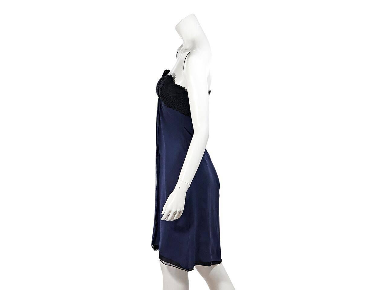 Product details:  Navy blue and black strapless dress by Carolina Herrera.  Sweetheart neckline.  Black lace bodice.  Floral applique at center bust.  Empire waist.  Concealed back zip closure. 
Condition: Pre-owned. Very good.
Est. Retail $ 995.00