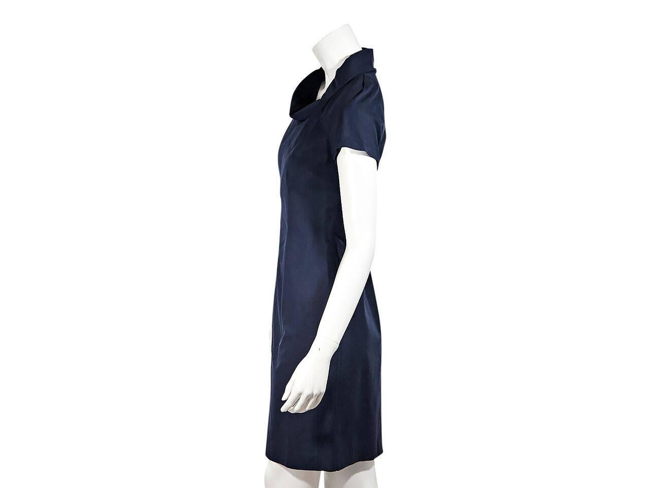 Product details:  Navy blue sheath dress by Prada.  Shawl neck.  Short sleeves.  Seam work creates a flattering silhouette.  Exposed back zip closure.  Back center hem vent.  Label size IT 38. 
Condition: Pre-owned. New with tags.
Est. Retail $