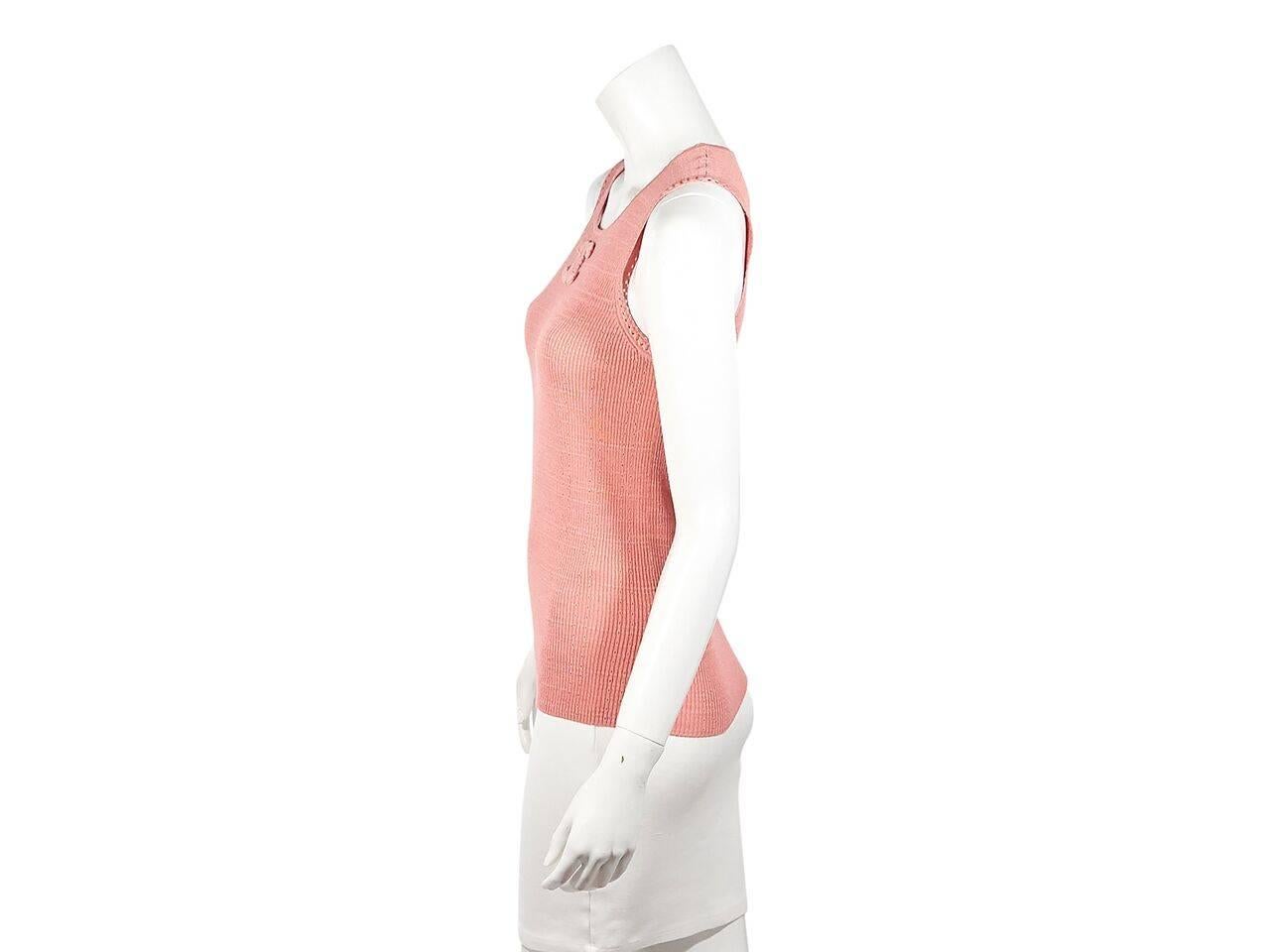 Product details:  Light coral cotton-blend knit top by Chanel.  Accented with a tonal logo applique.  Scoopneck.  Sleeveless.  Pullover style. 
Condition: Pre-owned. Very good.
Est. Retail $ 978.00