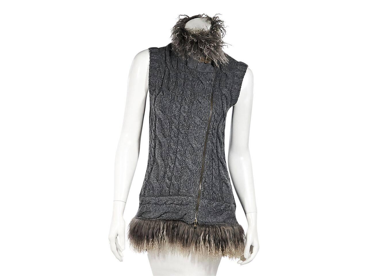 Product details:  Grey cashmere cable knit vest by Brunello Cucinelli.  Trimmed with Mongolian fur.  Stand collar.  Sleeveless.  Asymmetrical zip-front closure.    
Condition: Pre-owned. Very good.
Est. Retail $ 1,000.00