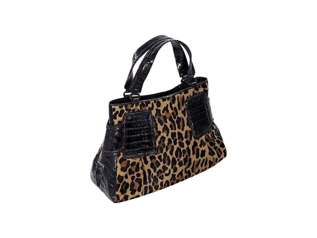 Product details:  Multicolor leopard-print pony hair tote bag by Nancy Gonzalez.  Trimmed with crocodile skin.  Dual shoulder straps.  Concealed magnetic tab closure.  Lined interior with inner zip and slide pockets.  Protective metal feet. 