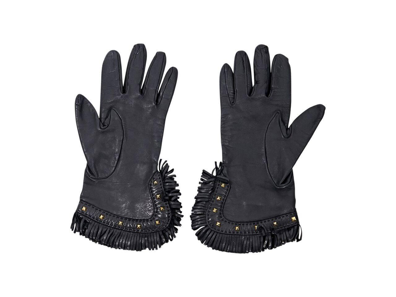 Product details:  Black leather gloves by Hermes.  Side slit.  Fringed cuffs with studded trim.  Goldtone hardware.  Size 7.
Condition: Pre-owned. Very good.
Est. Retail $ 970.00