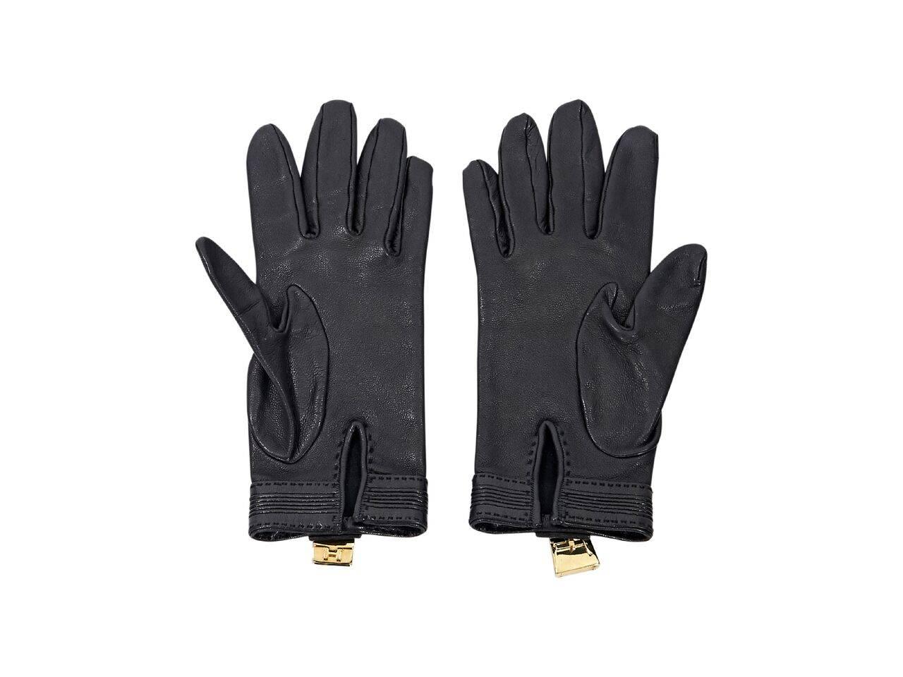 Product details:  Black lambskin leather Soya gloves by Hermes.  Accented with a padlock charm.  Goldtone hardware.
Condition: Pre-owned. Very good.
Est. Retail $ 970.00