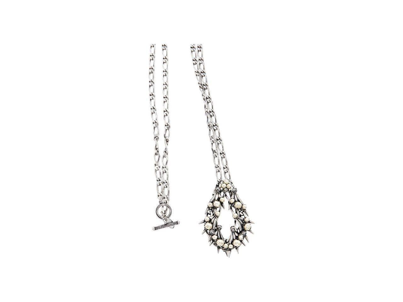 Product details:  Silver pendant necklace by Miriam Haskell.  Open teardrop pendant embellished with pearls and studs.  Toggle closure.
Condition: Pre-owned. Very good.
Est. Retail $ 498.00