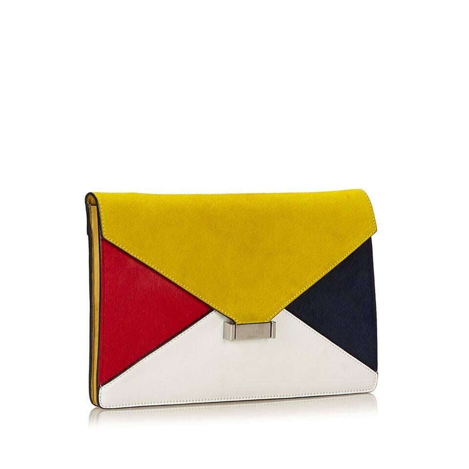 Product details:  Multicolor Diamond leather clutch by Celine.  Yellow suede front flap.  Push-lock closure.  Leather interior with inner zip compartment.  Silvertone hardware.  11"L x 7"H x 2"D.  
Condition: Pre-owned. Good. Faint