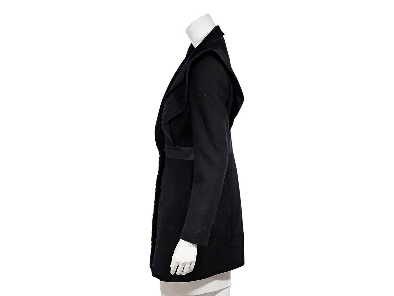 Product details:  Black virgin wool coat by Prada.  Long sleeves.  Banded waist.  Concealed closure.  Front lace panel.  
Condition: Pre-owned. Very good.
Est. Retail $ 2,995.00