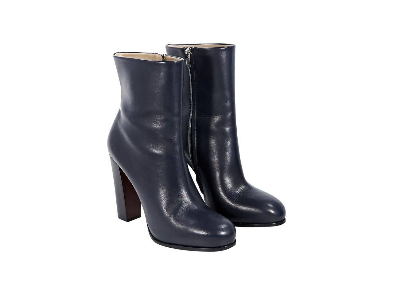 Product details:  Navy blue leather ankle boots by Celine.  Inner zip closure.  Round toe.  Block stacked heel.  
Condition: Pre-owned. Very good.
Est. Retail $ 1,575.00