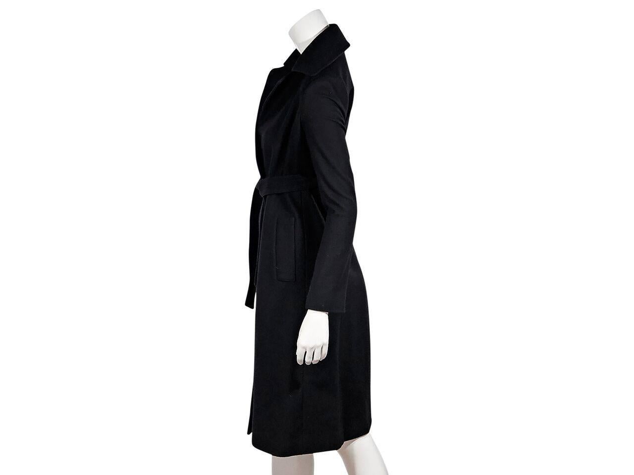 Product details:  Black wool-blend wrap coat by Diane von Furstenberg.  Notched lapel.  Long sleeves.  Tie belt waist.  Center back hem vent. 
Condition: Pre-owned. Very good.
Est. Retail $ 1,275.00