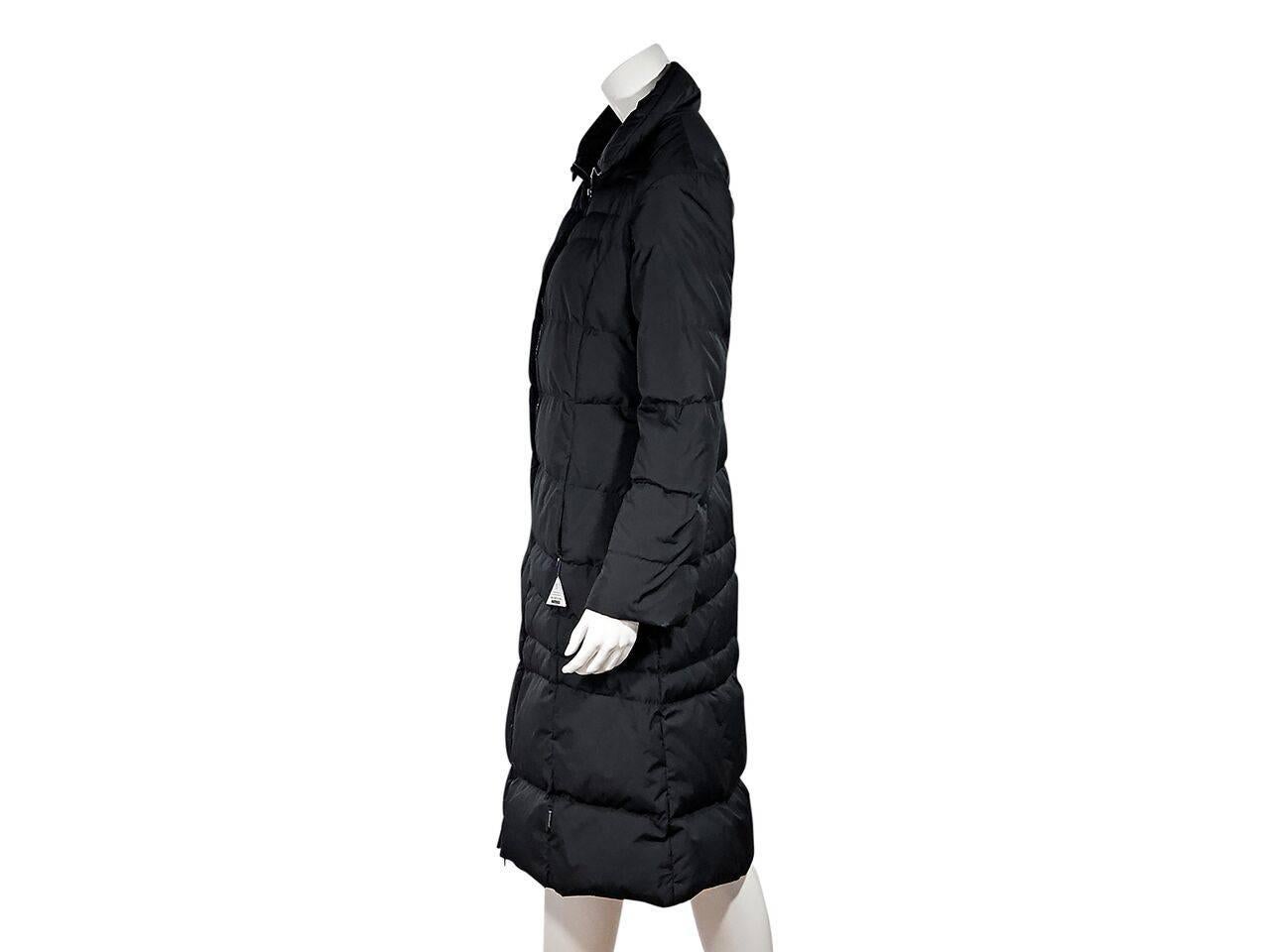 Product details:  Black puffer down coat by Moncler.  Spread collar.  Long sleeves.  Zip-front closure.  Waist zip pockets.  
Condition: Pre-owned. Very good.
Est. Retail $ 1,878.00