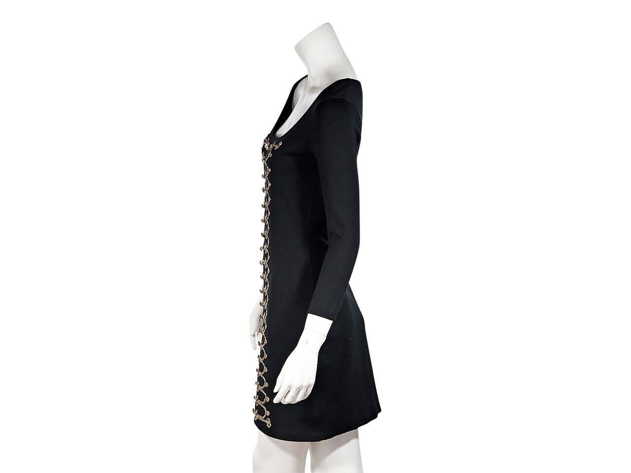 Product details:  Black knit sheath dress by Temperley London.  Deep scoopneck.  Three-quarter length sleeves.  Embellished front.  Pullover style. 
Condition: Pre-owned. Very good.
Est. Retail $ 528.00