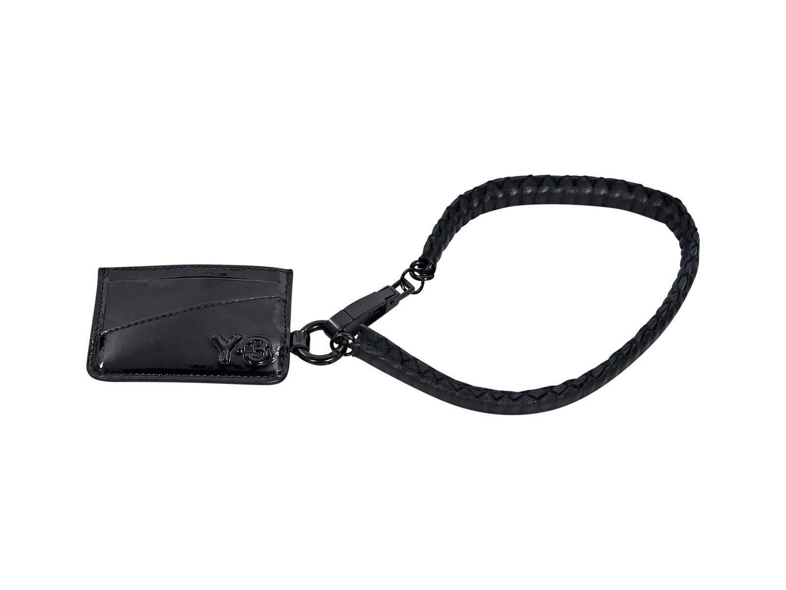 Product details:  Black patent leather card holder by Y-3.  Push clasp closure.  Black hardware.  4