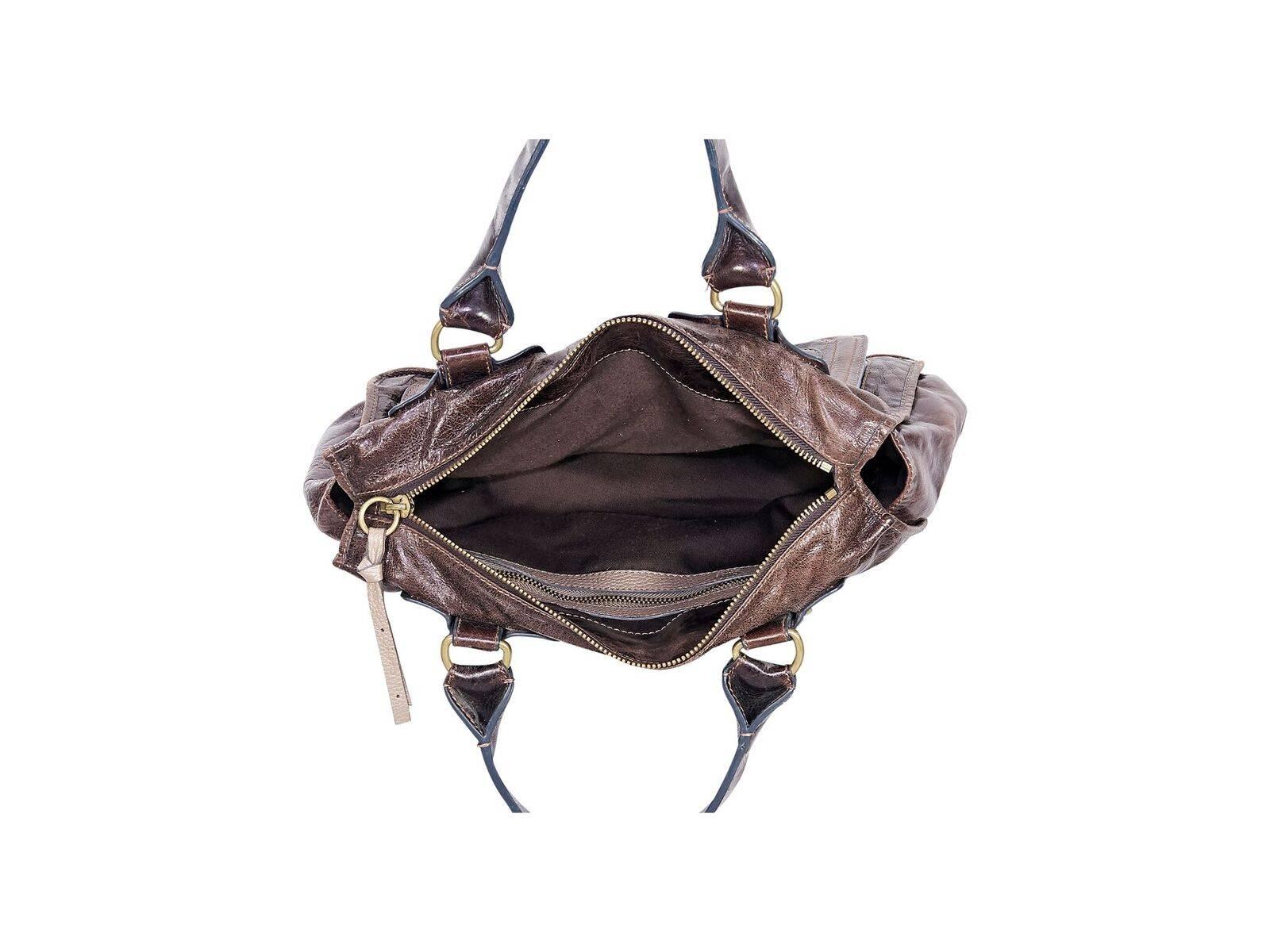Product details:  Vintage brown leather shoulder bag by Chloe.  Dual shoulder straps.  Top zip closure.  Lined interior with inner zip pocket.  Front exterior dual zip pocket.  Goldtone hardware.  15