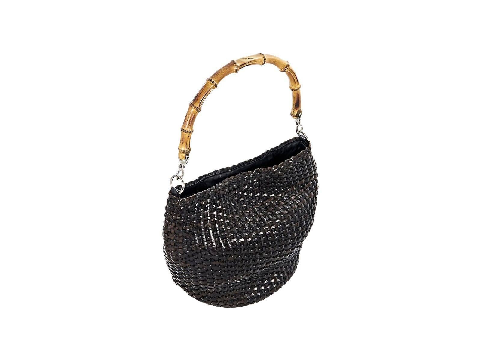 Product details:  Vintage black woven shoulder bag by Gucci.  Bamboo shoulder strap.  Magnetic snap closure.  Lined interior with inner zip pocket.  Silvertone hardware.  10.5