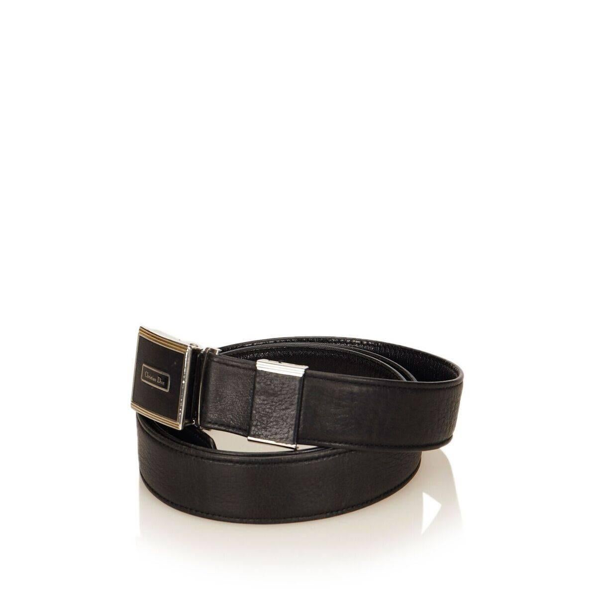 Product details:  Black leather Monsieur belt by Christian Dior.  Adjustable buckle closure.  Silver and goldtone hardware.  44