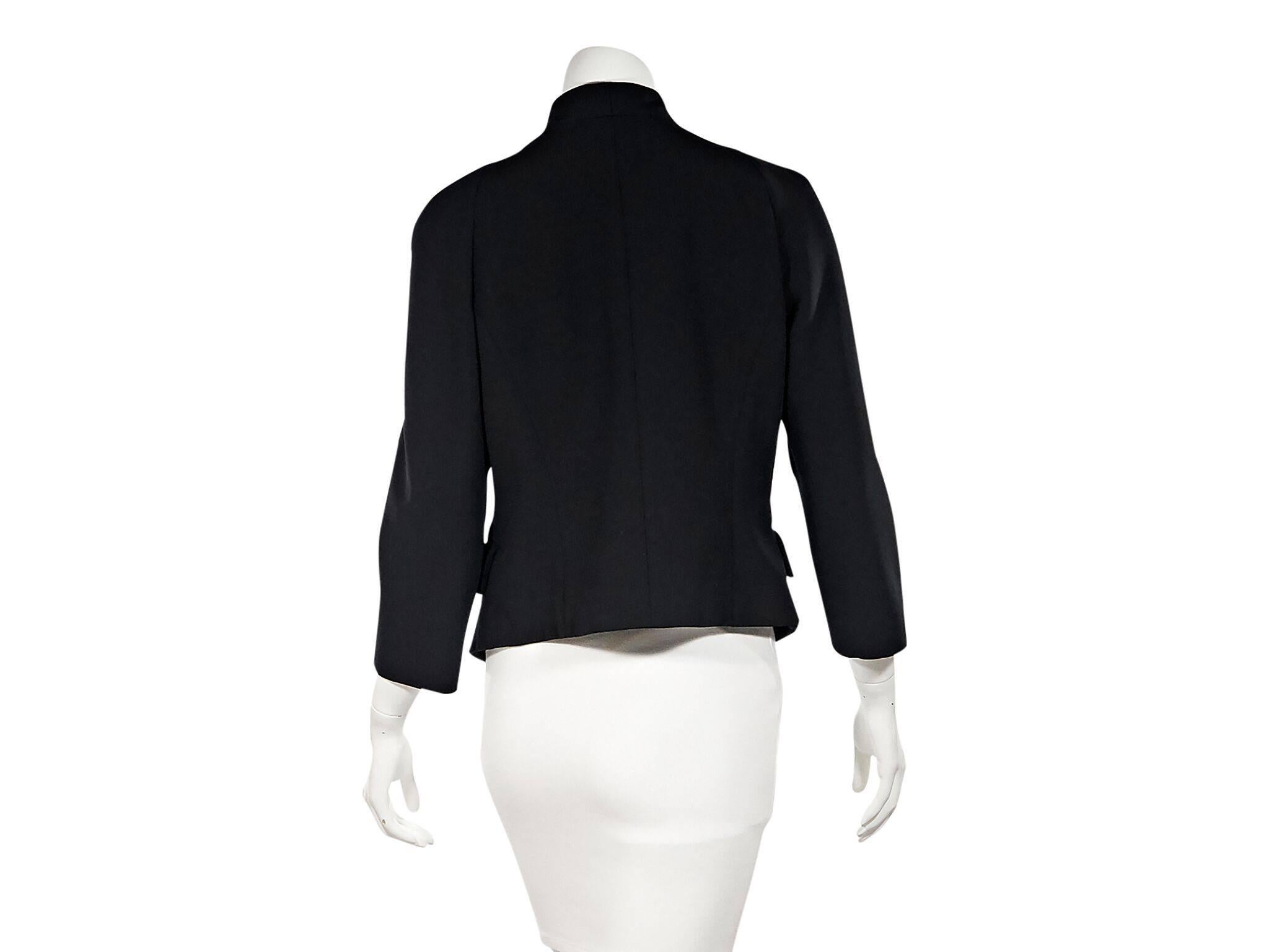 Product details:  Black jacket by Proenza Schouler.  Stand collar.  Three-quarter length sleeves.  Concealed front closure.  Waist flap pockets.  38