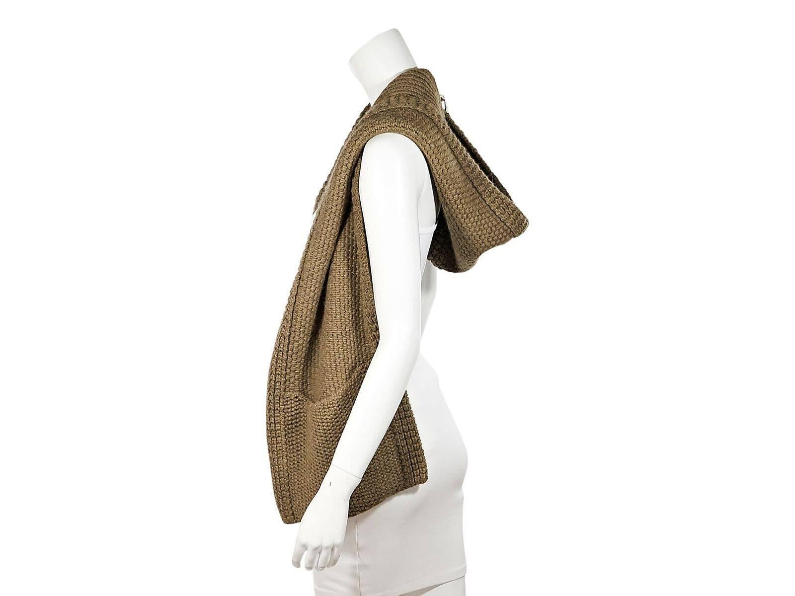 Product details:  Vintage tan alpaca knit snood by Hermes.  Doubles as a vest and scarf.  Hood and slide pockets.  
Condition: Pre-owned. Very good. 
Est. Retail $1,198