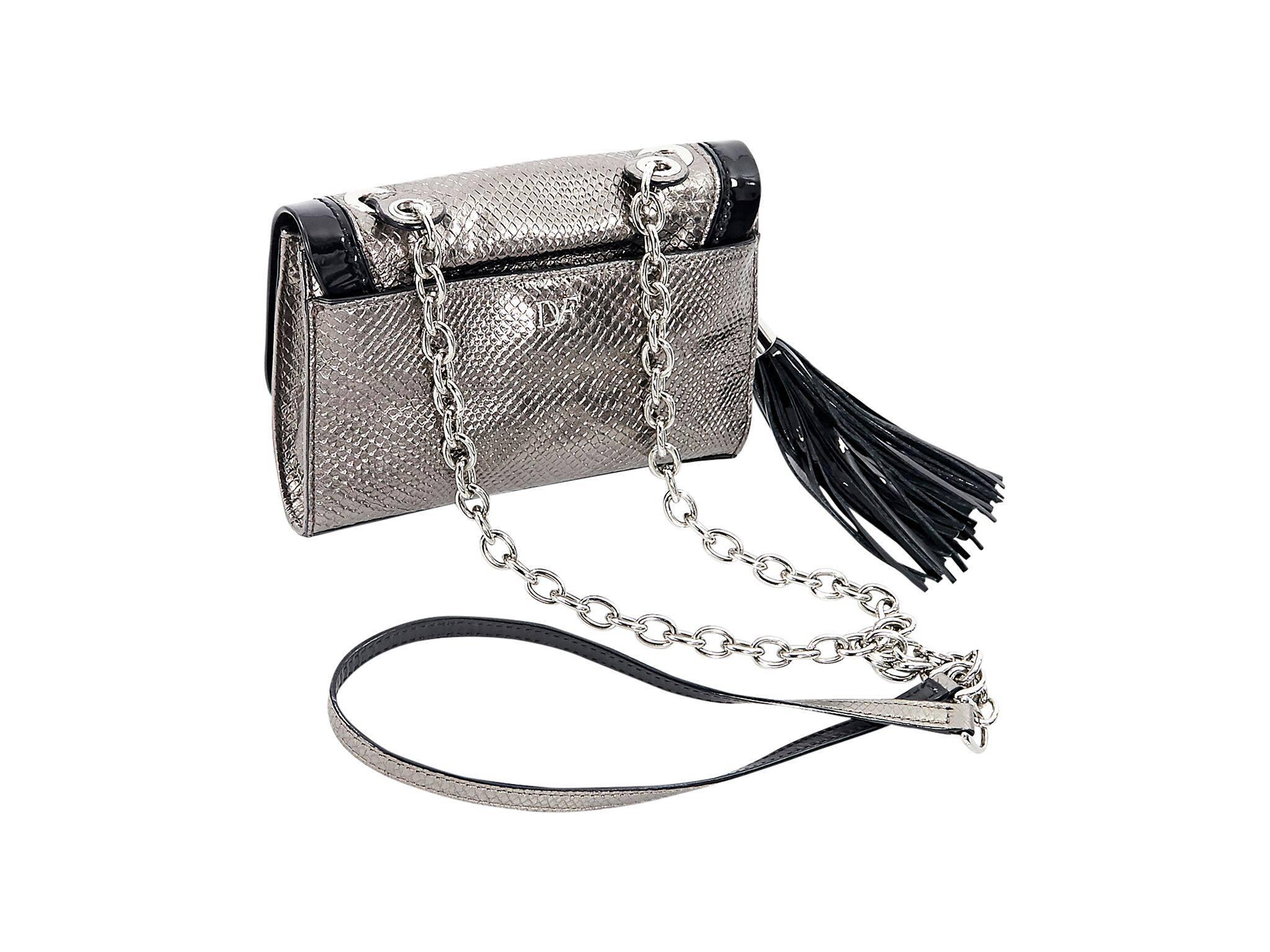 Product details:  Silver embossed leather mini crossbody bag by Diane von Furstenberg.  Trimmed with black patent leather.  Chain and leather crossbody strap.  Front flap with twist-lock closure.  Lined interior with inner zip pocket.  Side tassel