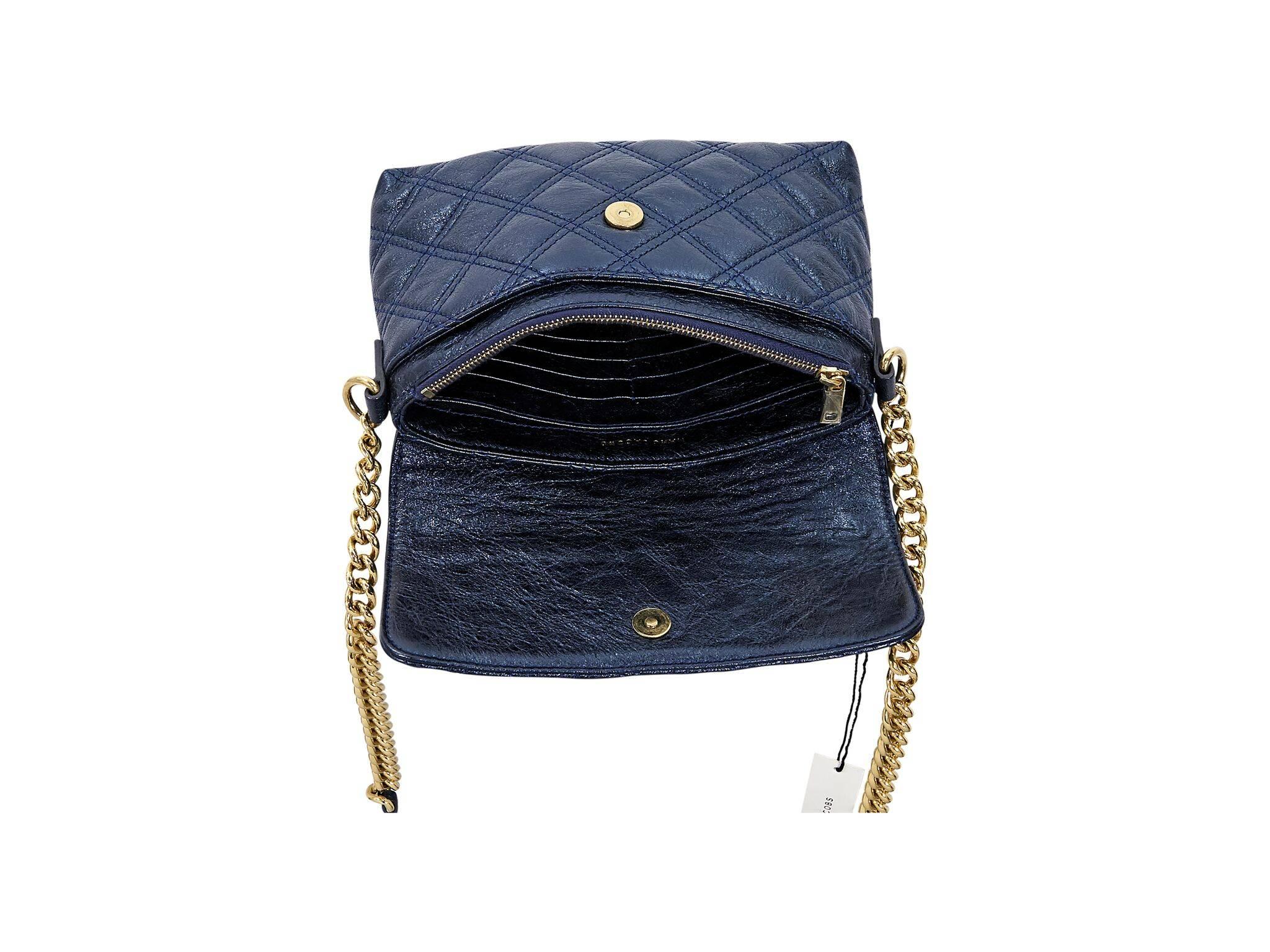 Product details:  Metallic blue quilted leather crossbody bag by Marc Jacobs.  Accented with a faux push-lock closure.  Chain and leather crossbody strap.  Front flap with magnetic zip closure.  Lined interior with multiple inner credit card slots