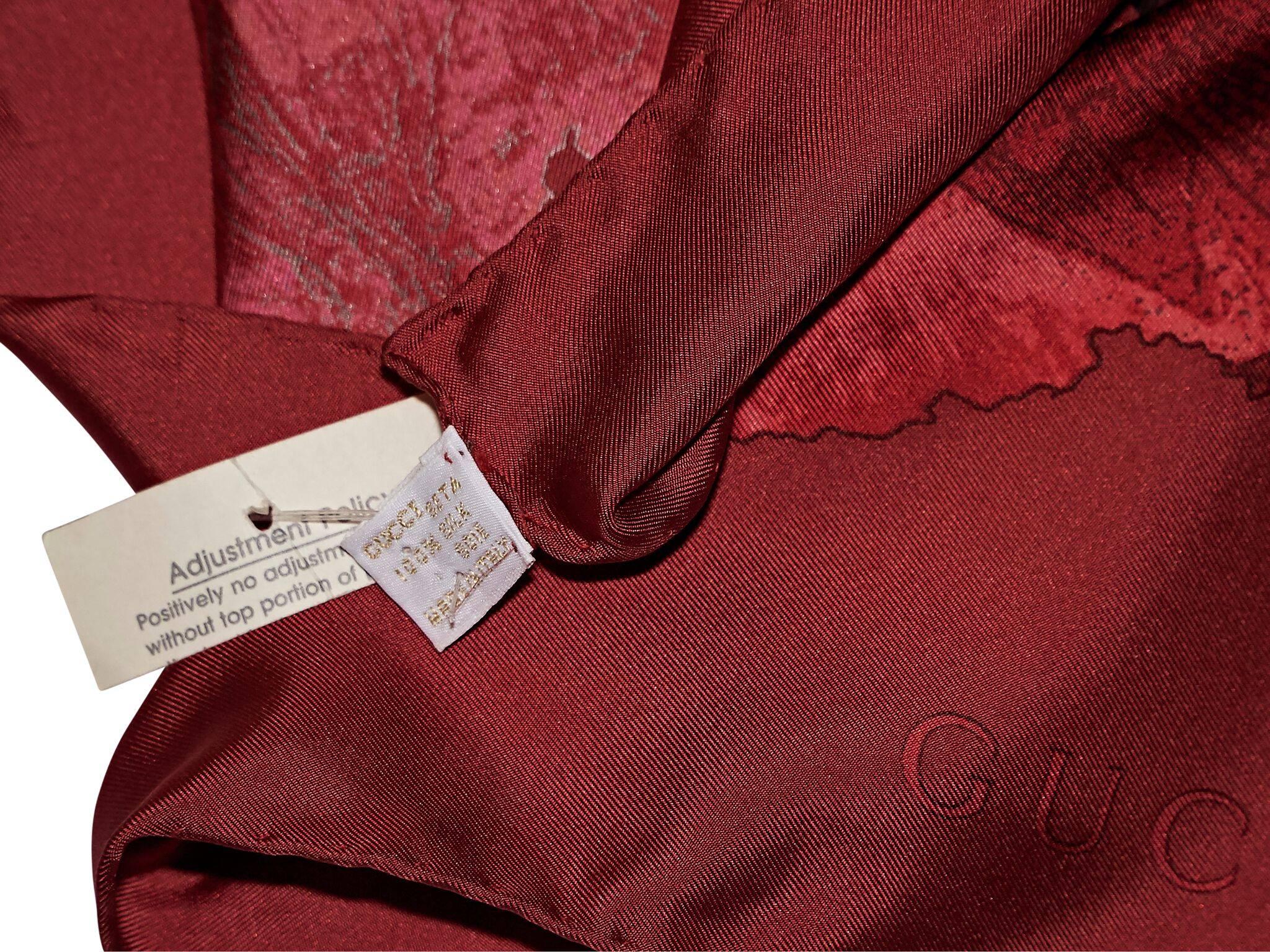 Product details:  Red floral-printed silk scarf by Gucci.  
Condition: Pre-owned. Very good.
Est. Retail $398