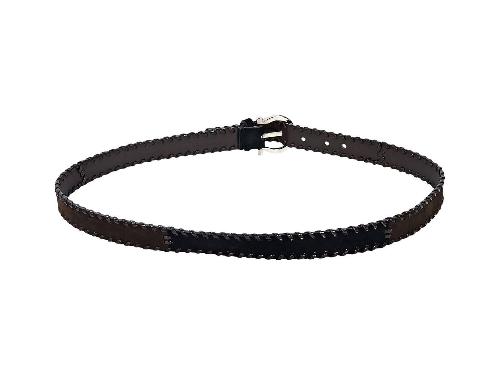 Product details:  Brown suede belt by Salvatore Ferragamo.  Leather whipstitched trim.  Adjustable buckle closure.  Silvertone hardware.  36
