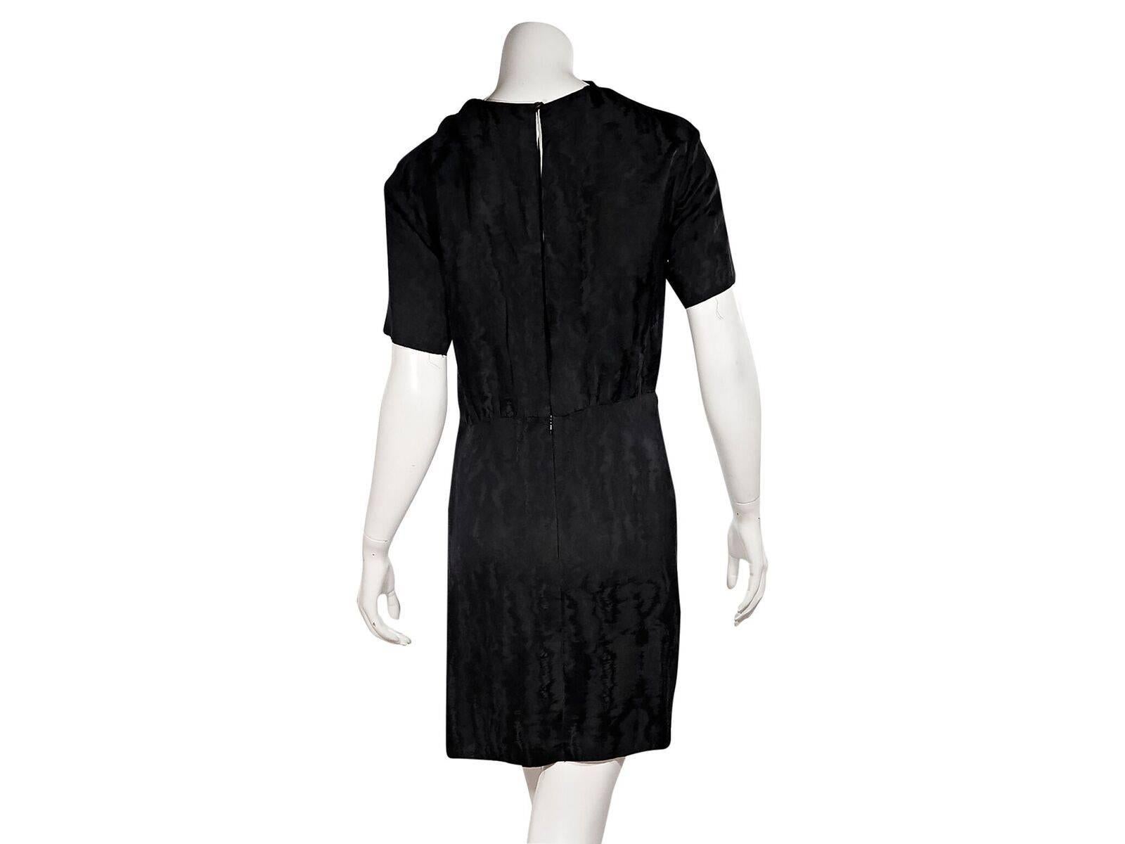 Product details:  Black ruffle-trimmed sheath dress by Isabel Marant.  Crewneck.  Short sleeves.  Back button with keyhole cutout.  Concealed zip closure.  Center back hem vent.  Frayed edges.  Label size FR 38.
Condition: Pre-owned. Very good.
Est.