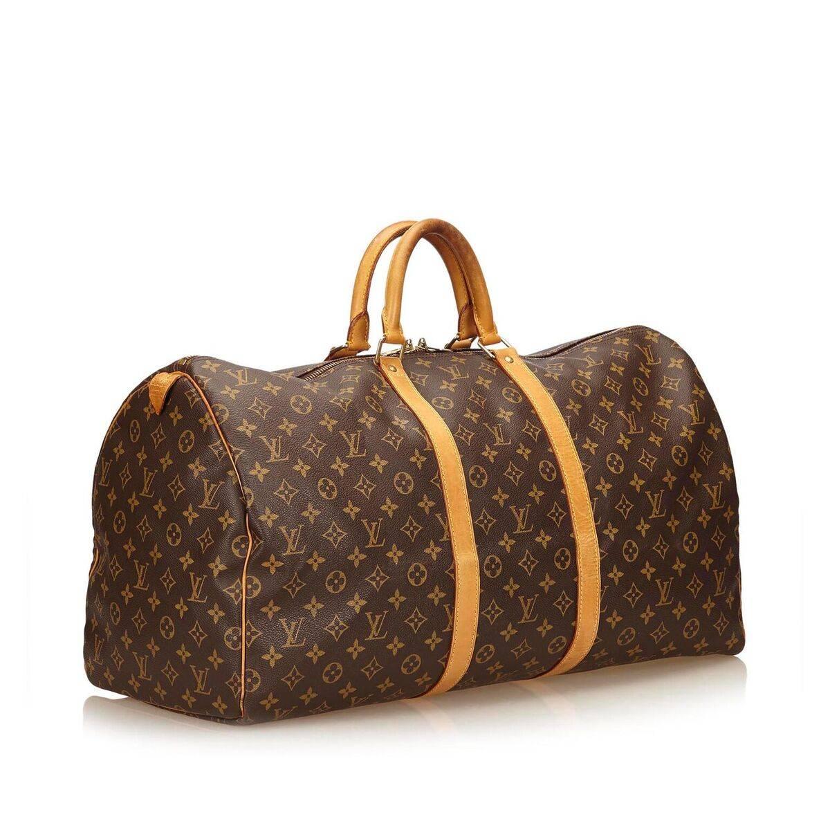 Product details:  Brown coated canvas monogram Keepall 55 duffel bag by Louis Vuitton.  Trimmed with tan leather.  Dual carry handles.  Top dual zip closure.  Goldtone hardware.  22