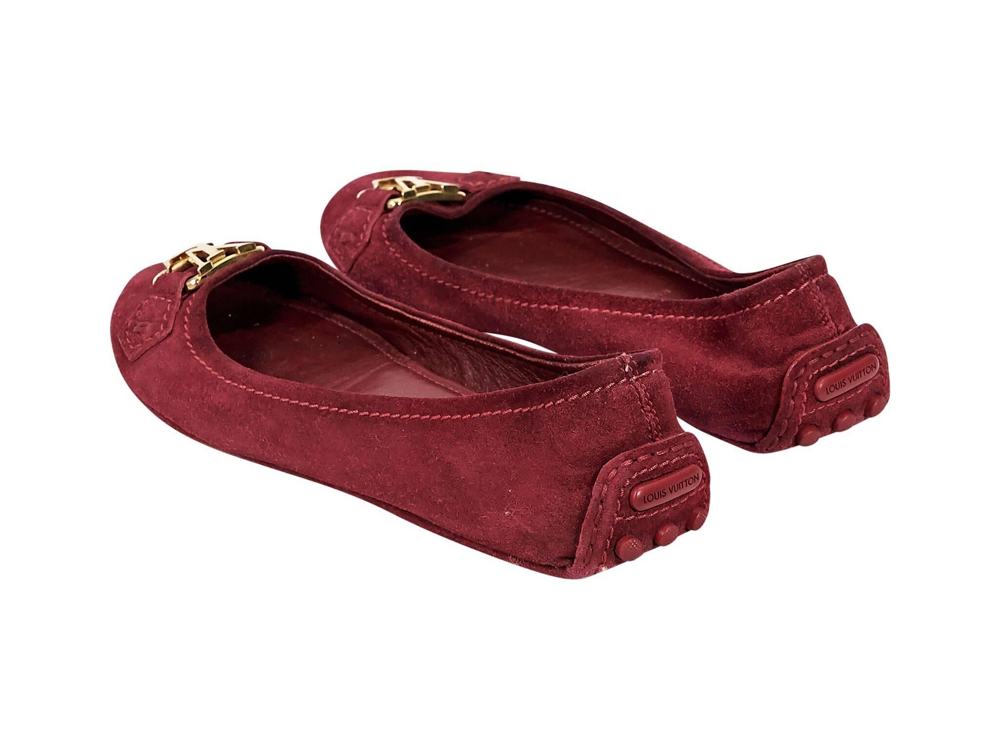 Product details:  Red suede driving loafers by Louis Vuitton.  Logo hardware accents vamp.  Round toe.  Goldtone hardware.  Slip-on style.
Condition: Pre-owned. Good.
Est. Retail $798