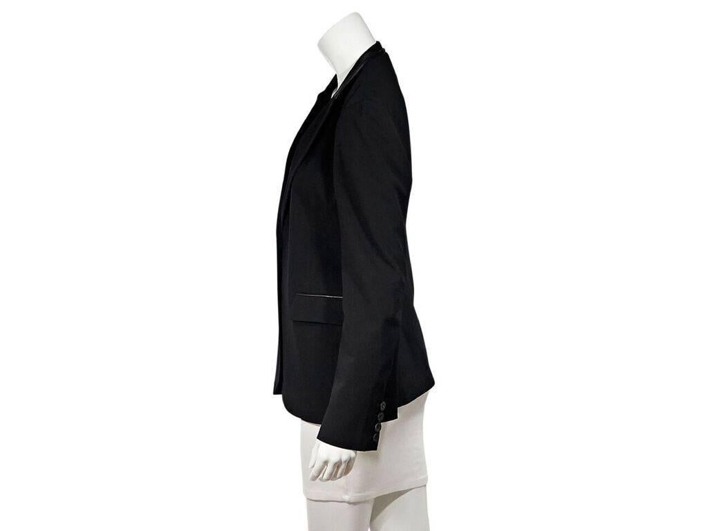 Product details:  Black leather-trimmed blazer by Gucci.  Notched lapel.  Long sleeves.  Four-button detail at cuffs.  Double button closure.  Waist flap pockets.  Label size IT 42.  38