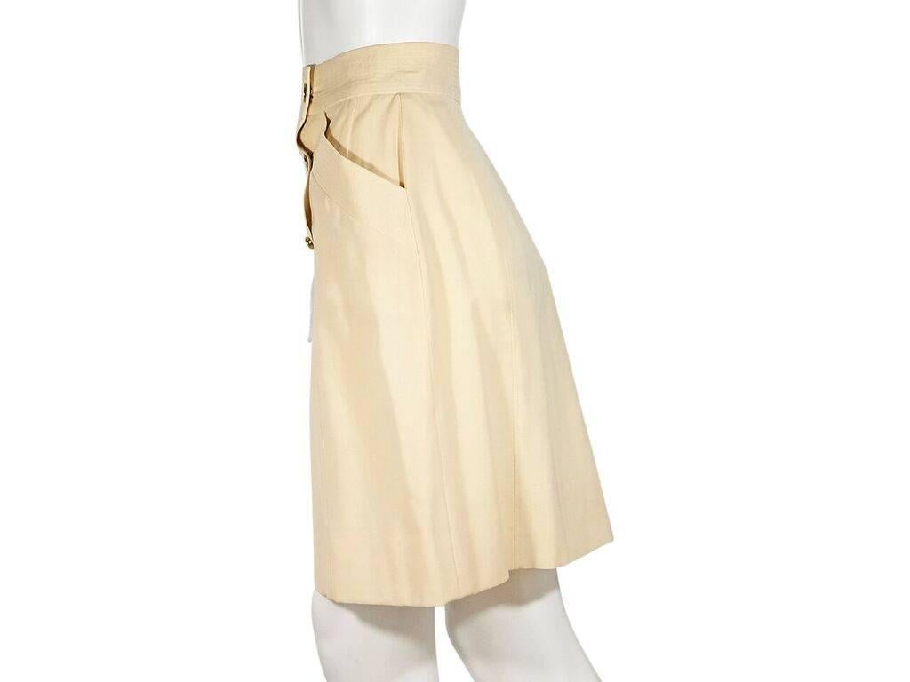 Product details:  Vintage cream wool skirt by Chanel.  Banded waist.  Sailor button front.  Waist slide pockets.  Label size FR 38.  26