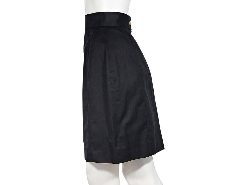 Product details:  Vintage black cotton skirt by Chanel.  Banded waist.  Button and zip back closure.  Label size FR 38.  26