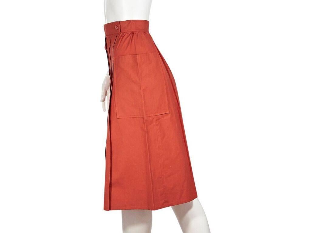 Product details:  Vintage orange pleated skirt by Gucci.  Banded waist.  Button-front closure.  Side patch pockets.  Label size IT 40.  25
