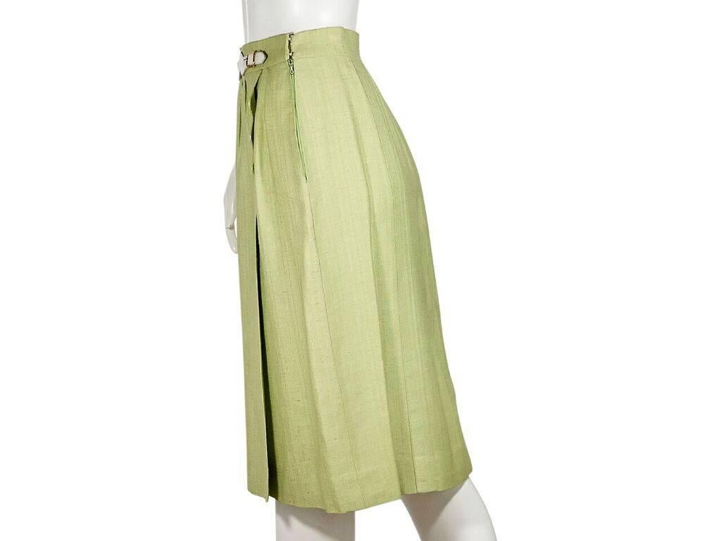 Product details:  Vintage green skirt by Hermes.  Banded waist with belt front detail.  Concealed side zip closure.  Label size FR 38.  28