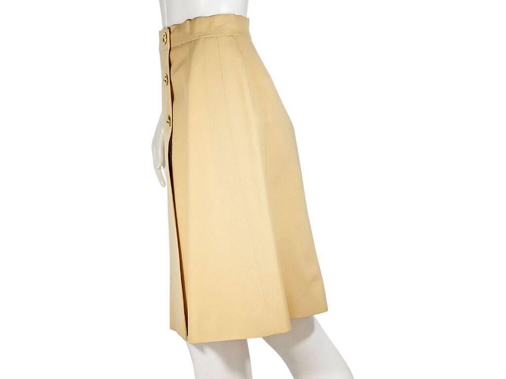 Product details:  Vintage cream skirt by Hermes Sport.  Banded waist.  Button-front closure.  Front inverted box pleat.  Back center hem vent.  27