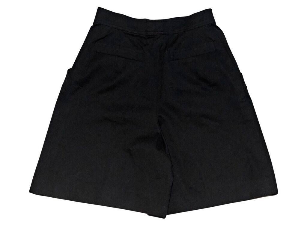 Product details:  Vintage black cotton high-waisted shorts by Chanel.  Banded waist.  Button and zip fly closure.  Waist slide pockets.  Back besom pockets.  25