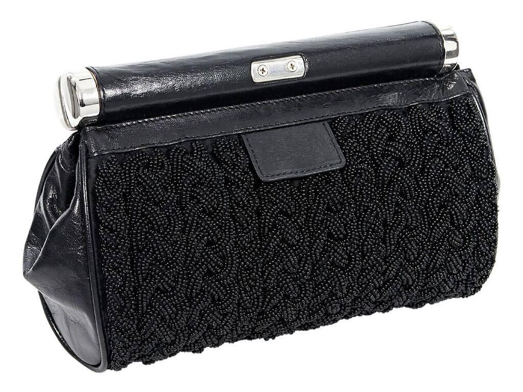 Product details:  Black beaded and leather clutch by Dries van Noten.  Top twist-lock closure.  Lined interior with inner slide pocket.  Silvertone hardware.  Dust bag included.  9