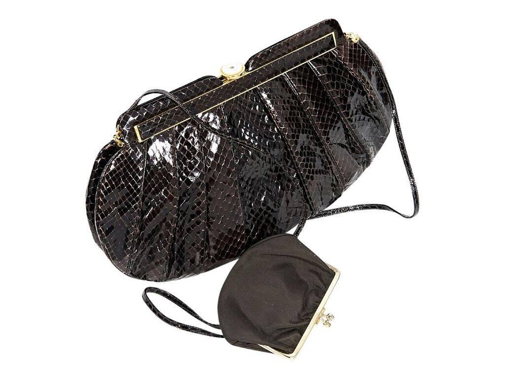 Product details:  Brown snakeskin clutch by Judith Leiber.  Tuck-away shoulder strap.  Top push-lock closure.  Lined interior with inner zip and slide pockets and removable coin pouch.  Goldtone hardware.  Dust bag included.  12
