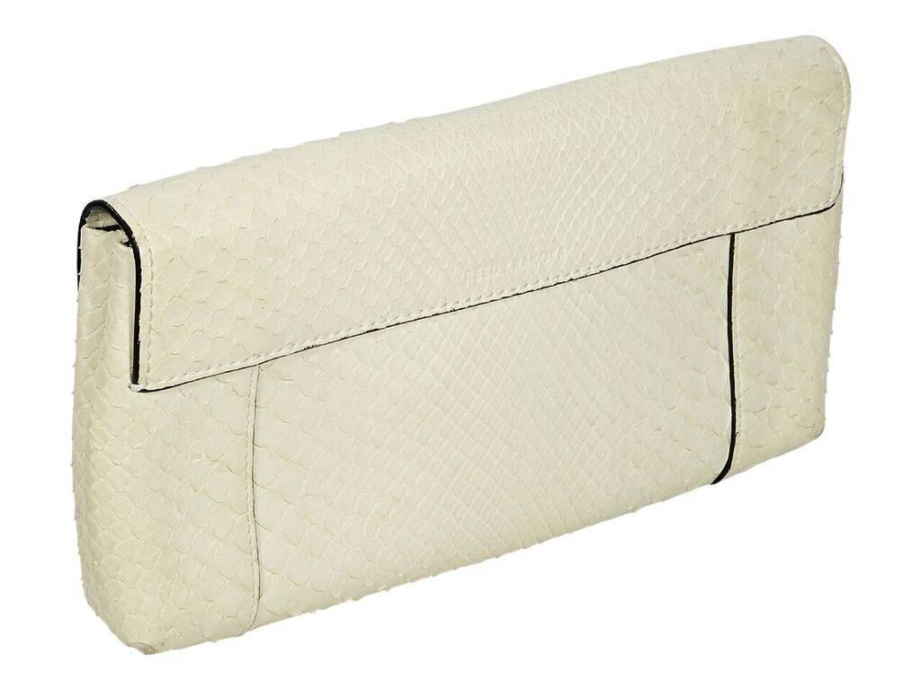 Product details:  White python clutch by Reed Krakoff.  Front flap.  Leather lined interior with two inner open compartments and inner zip pocket.  Silvertone hardware.  10.5