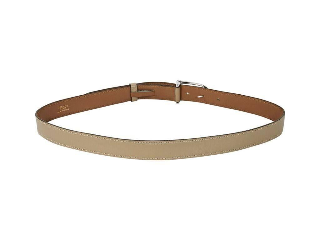 Product details:  Vintage tan leather belt by Hermes.  Adjustable buckle closure.  Silvertone hardware.  28