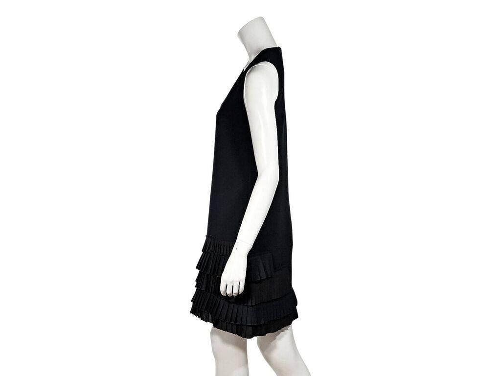 Product details:  Black shift dress by Victoria Beckham.  Scoopneck.  Sleeveless.  Concealed back zip closure.  Pleated tiered hem.  32
