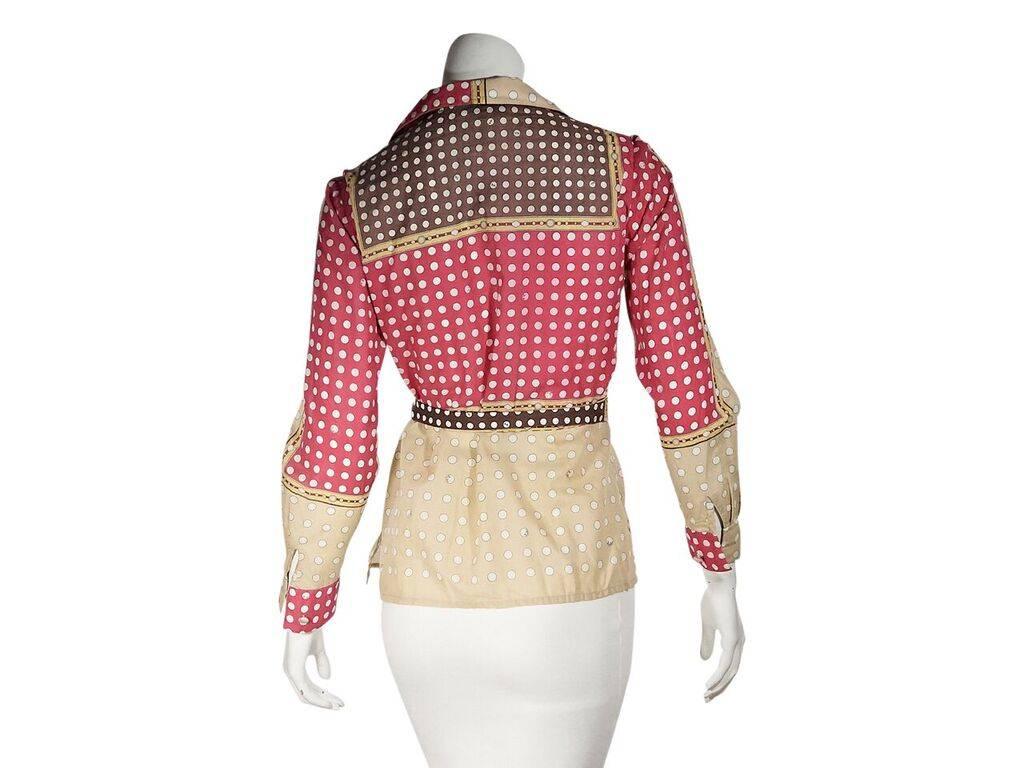Product details:  Vintage multicolor polka-dot cotton blouse by Emilio Pucci.  Notched lapel.  Long sleeves.  Button-front closure.  Self-tie belted waist.  36